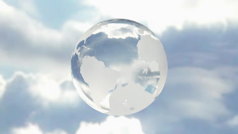 3D-rotating-crystal-planet-earth-floating-in-a-clear-blue-sky.-Glass-world-with-orb-effect